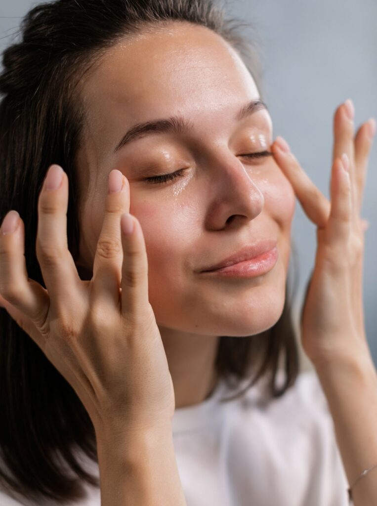 woman putting on under eye gel