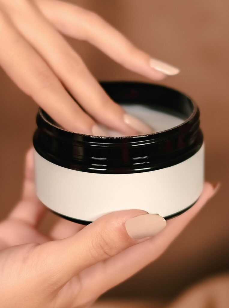 taking out moisturizer from a jar