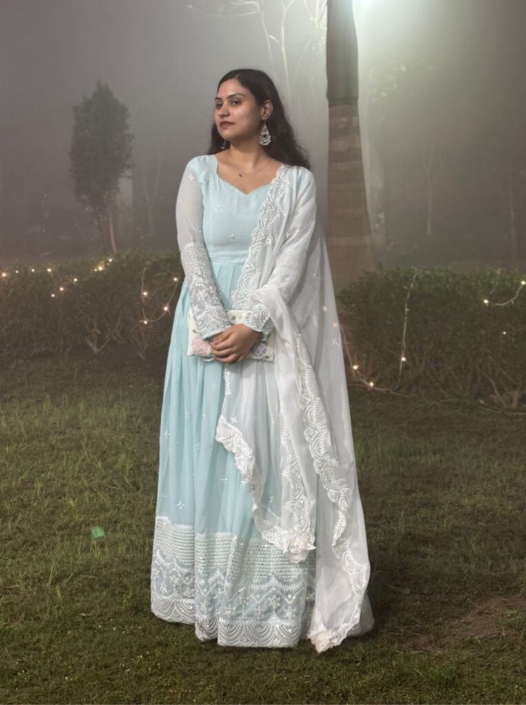woman posing with attitude in light blue and white anarkali dress