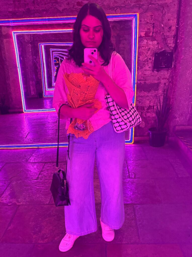 woman taking full-length mirror selfie